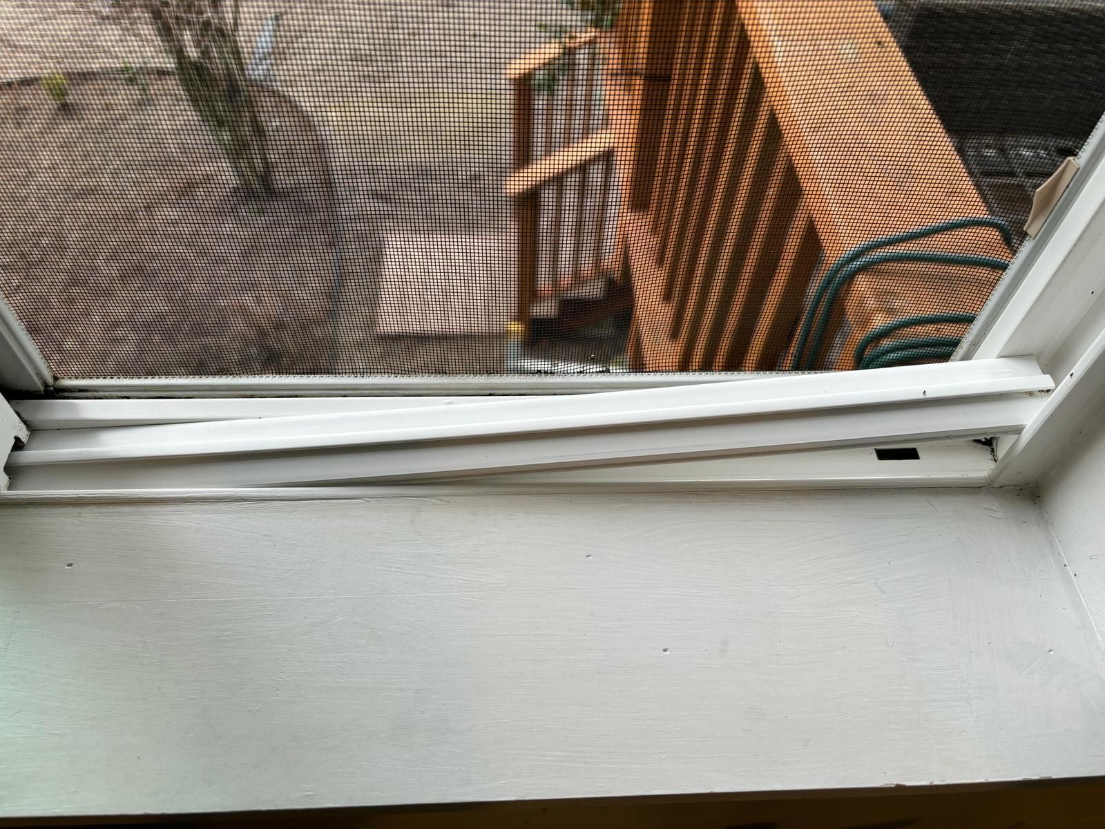 A close up of a window with a screen on it