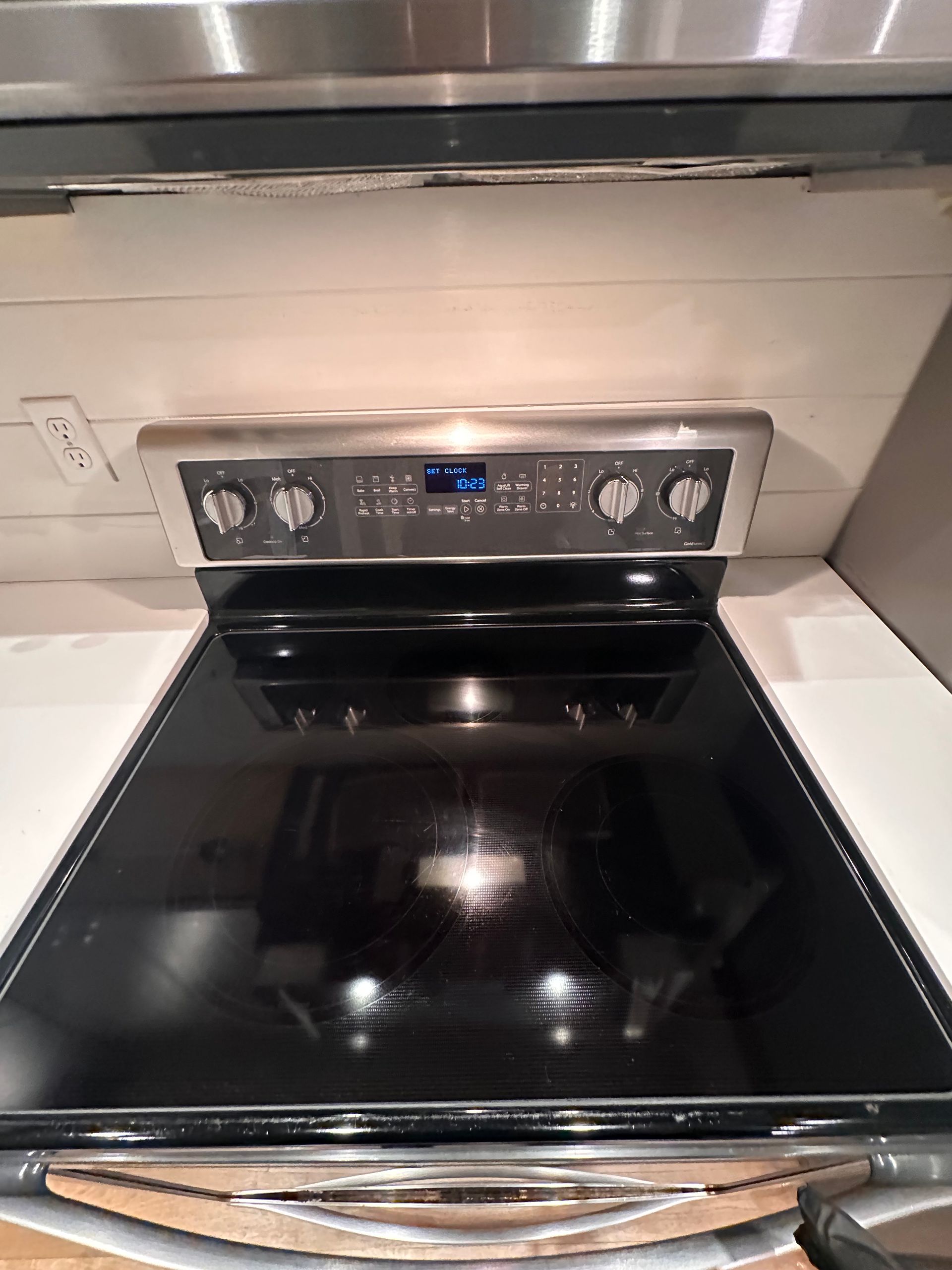 A black stove top oven is sitting on top of a counter in a kitchen.