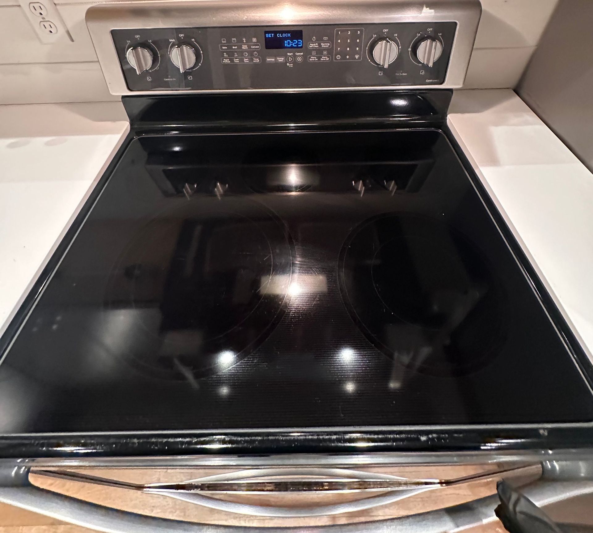 A stove top oven with a black glass top