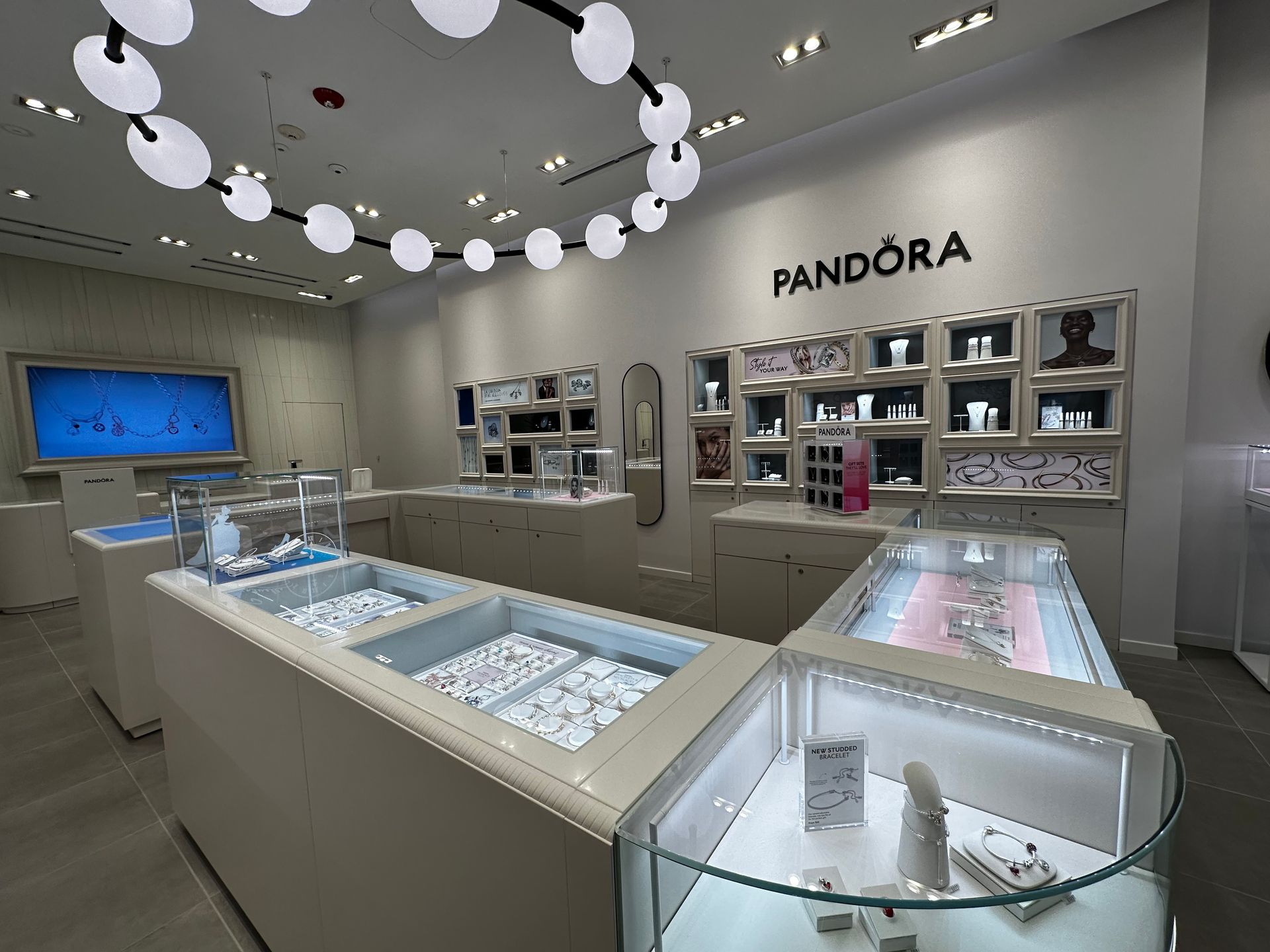 A pandora store with lots of jewelry on display