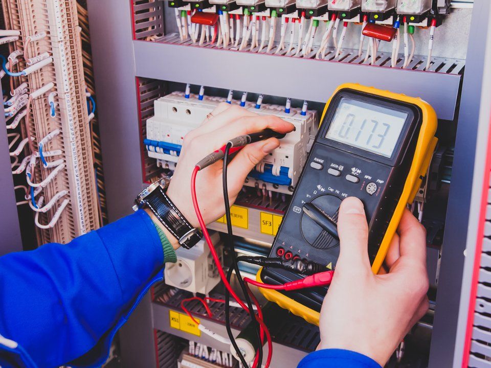 Electrician Measures Voltage Using Tester — Peoria, IL — Oberlander Electric