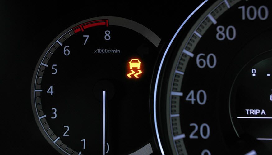 A close up of a car 's dashboard with a warning light on it. | Import Specialty Service