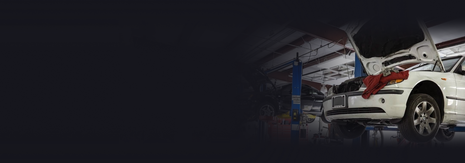 A white car is parked on the side of a road at sunset. | Import Specialty Service