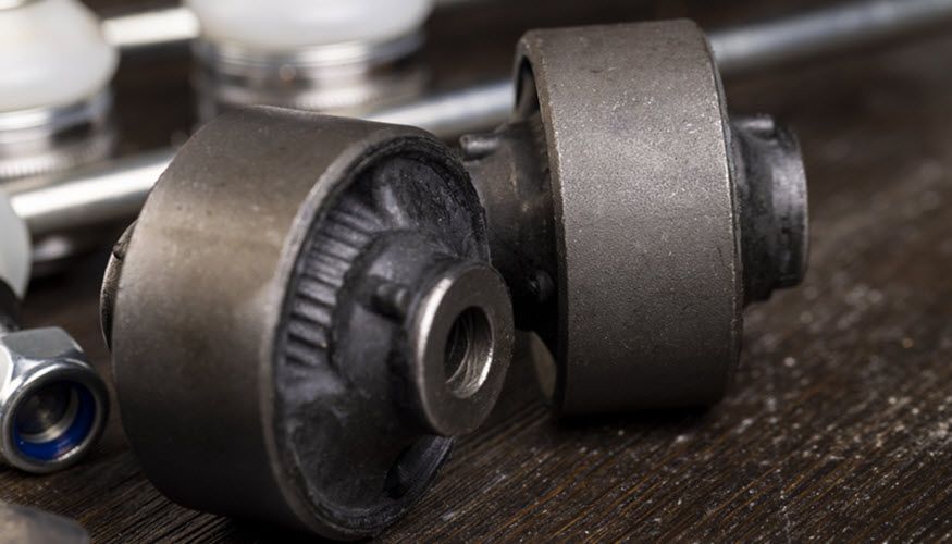 A close up of a pair of bearings on a wooden table. | Import Specialty Service