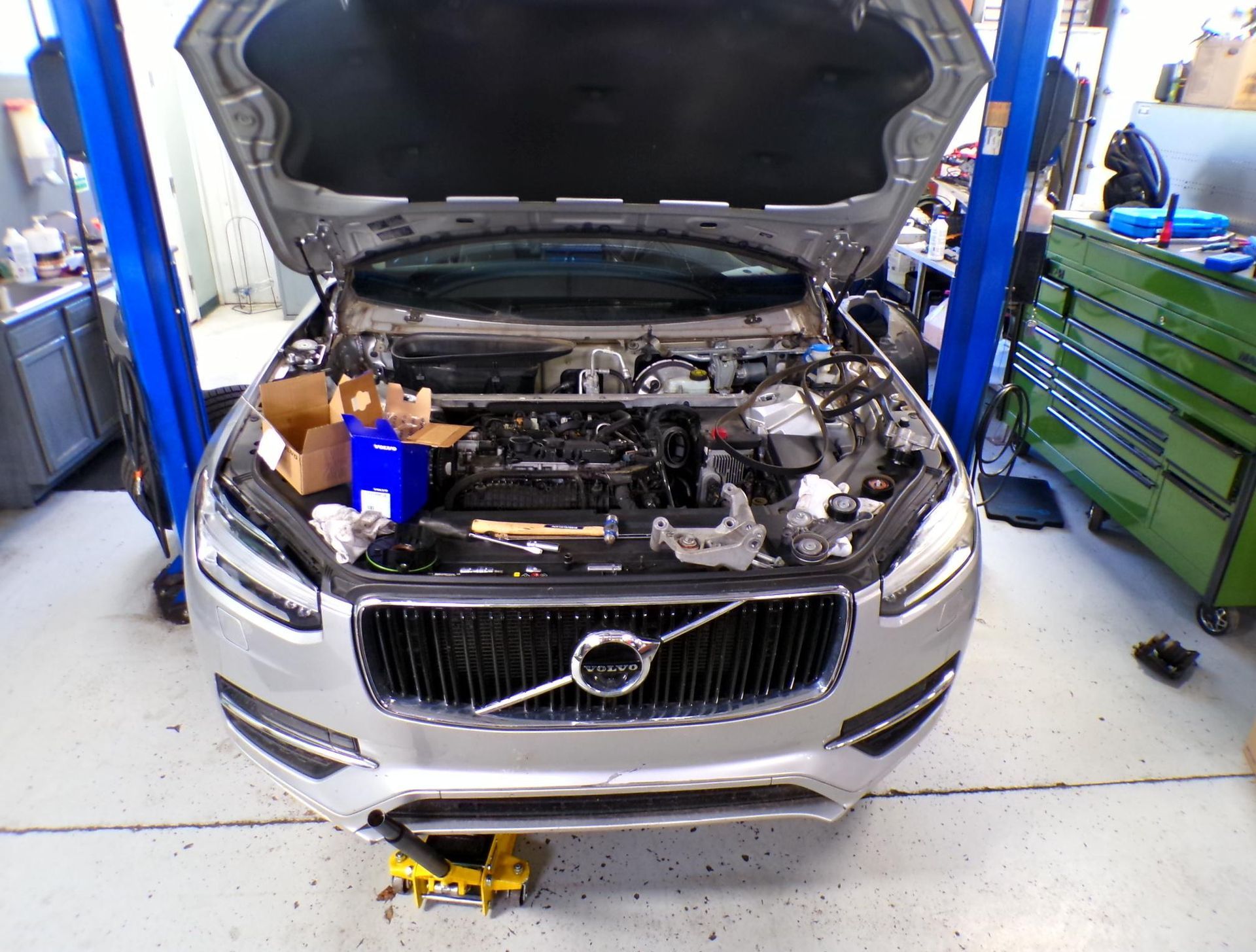 A silver volvo with the hood open in a garage | Import Specialty Service