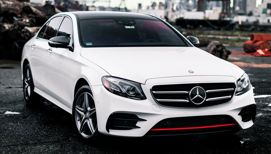 A white mercedes benz is parked in a parking lot. | Import Specialty Service