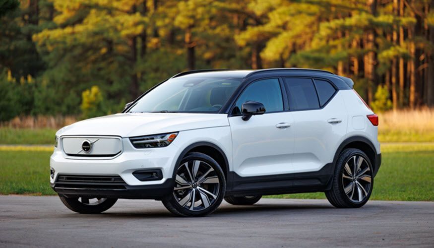 A white volvo xc40 electric suv is parked on the side of a road. | Import Specialty Service