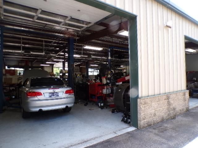A car is parked in a garage with the door open | Import Specialty Service