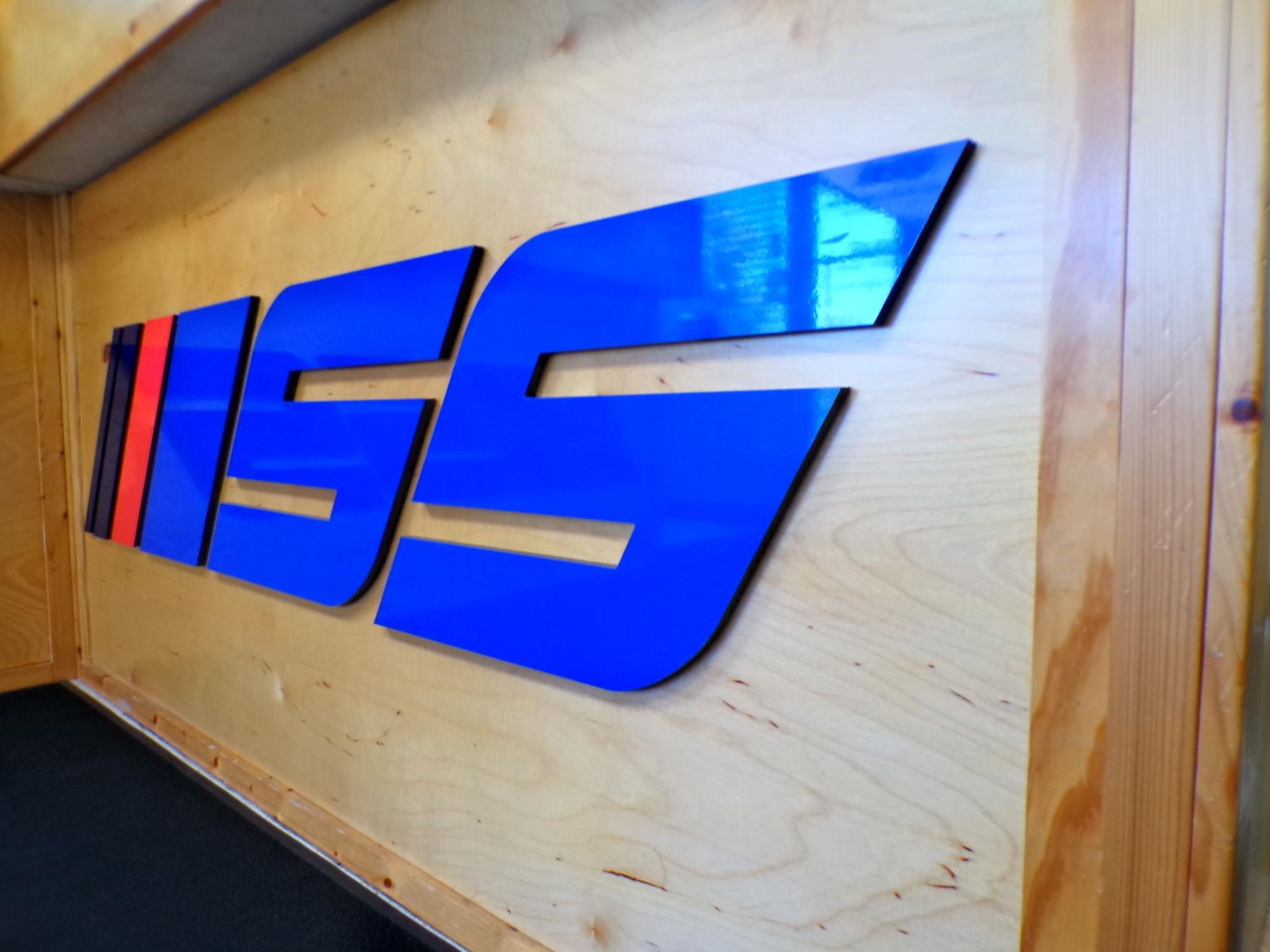 A blue sign that says miss on a wooden wall | Import Specialty Service