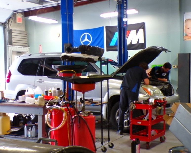 A man is working on a mercedes in a garage | Import Specialty Service
