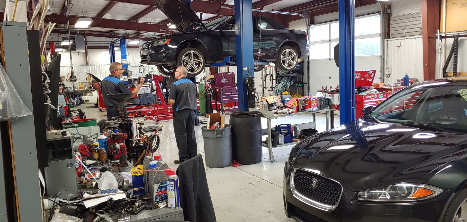 A car is being worked on in a garage. | Import Specialty Service