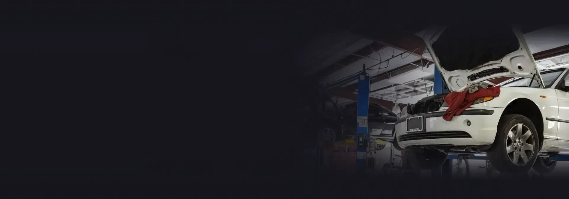 A white car raised up in the garage with the hood up in Nashville, TN | Import Specialty Service