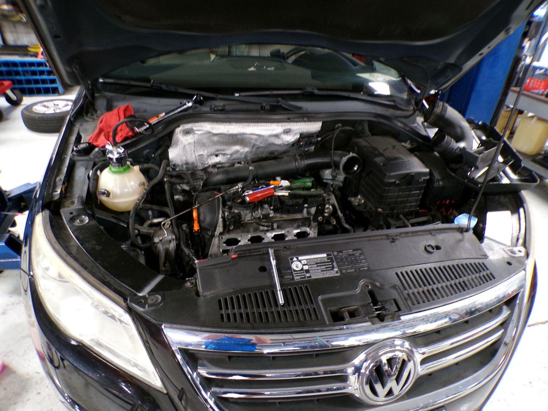 The hood of a volkswagen is open and the engine is visible | Import Specialty Service