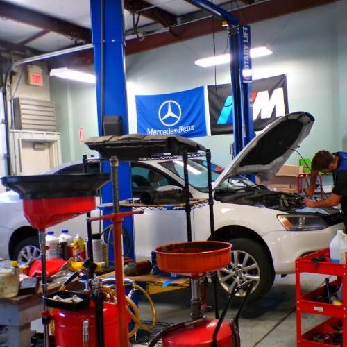 A man is working on a mercedes in a garage | Import Specialty Service
