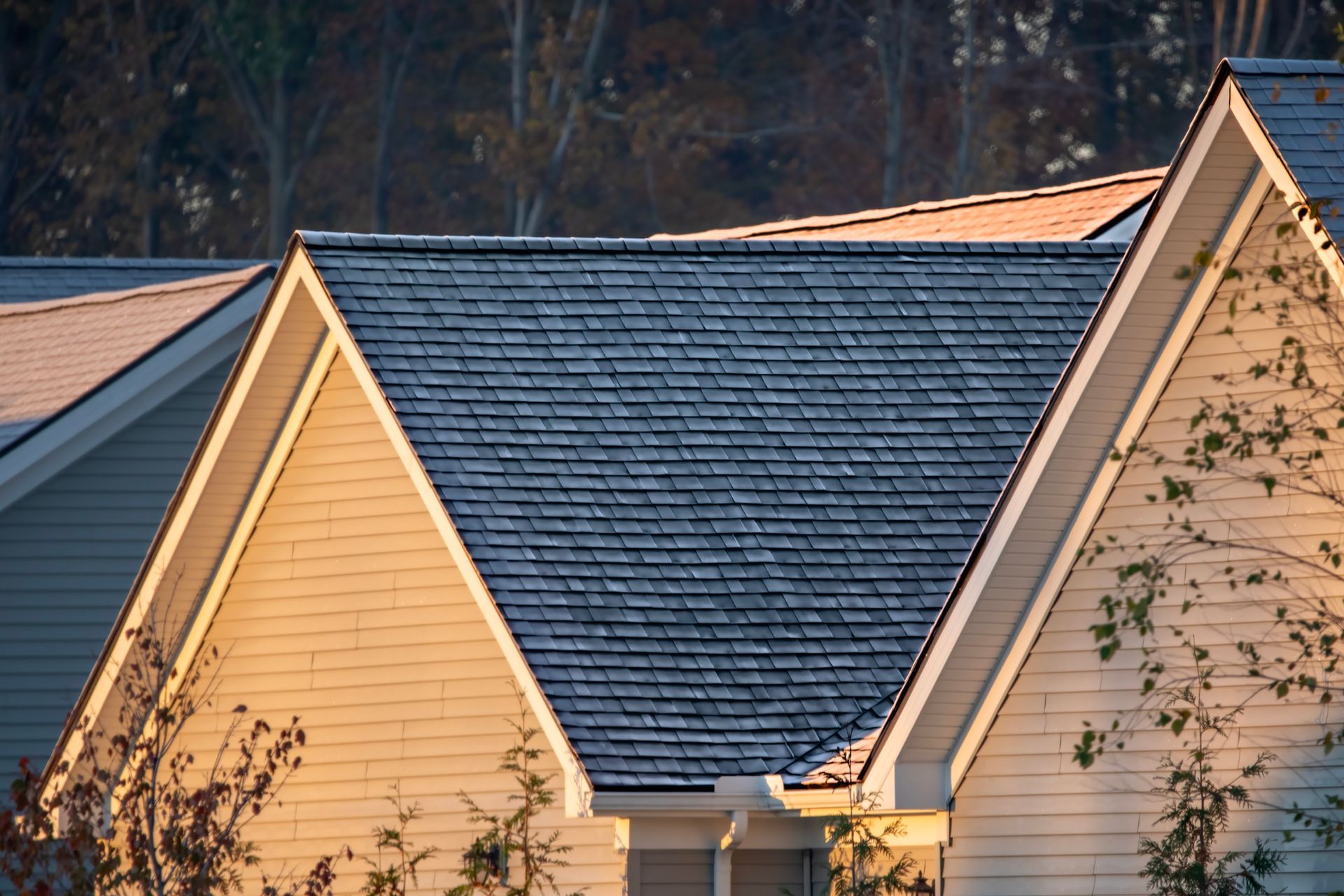 A man is kneeling down on a tiled roof.