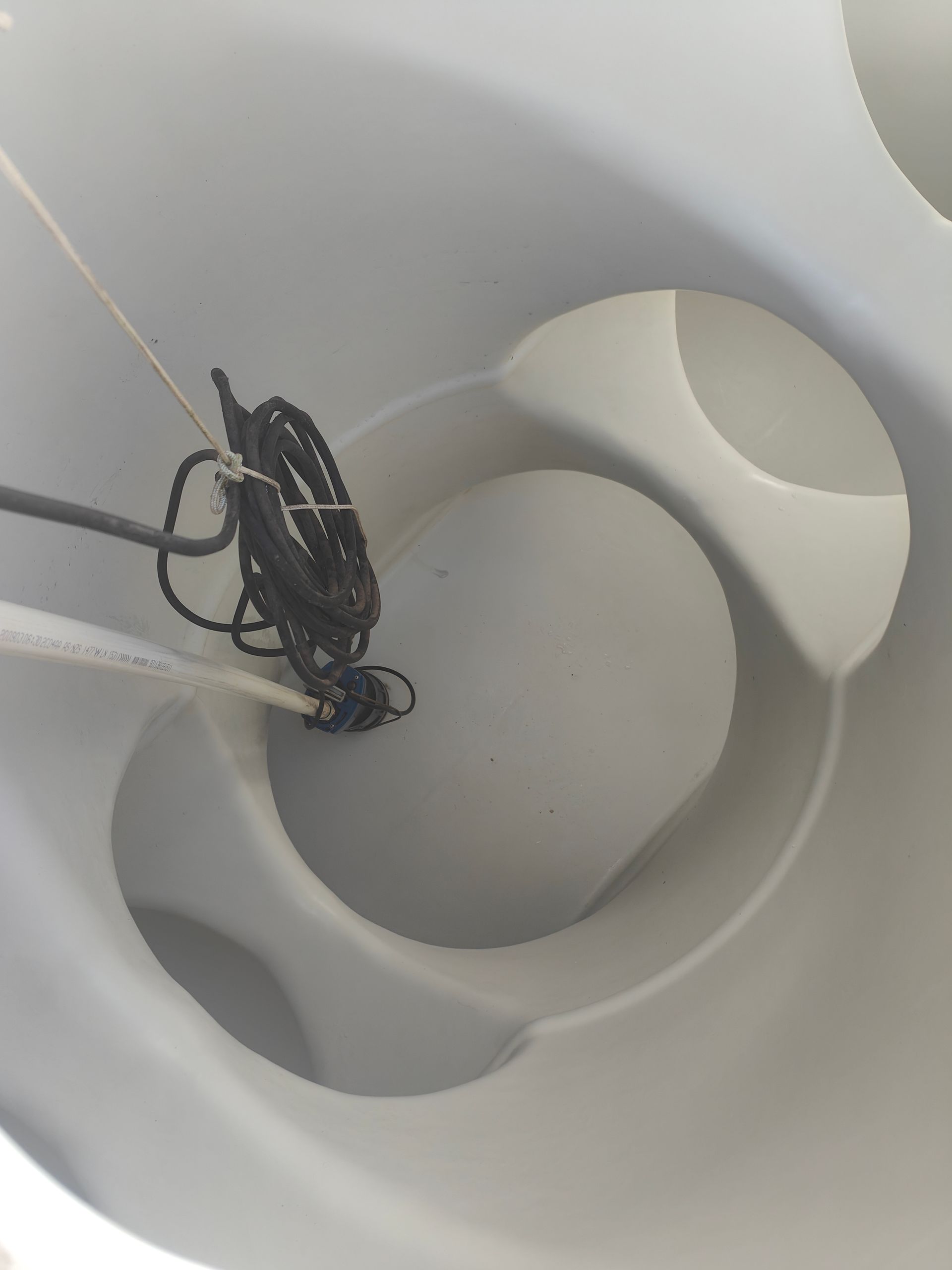 The inside of a water tank with cords dangling from above - Hastings Water Care in Port Macquarie NSW