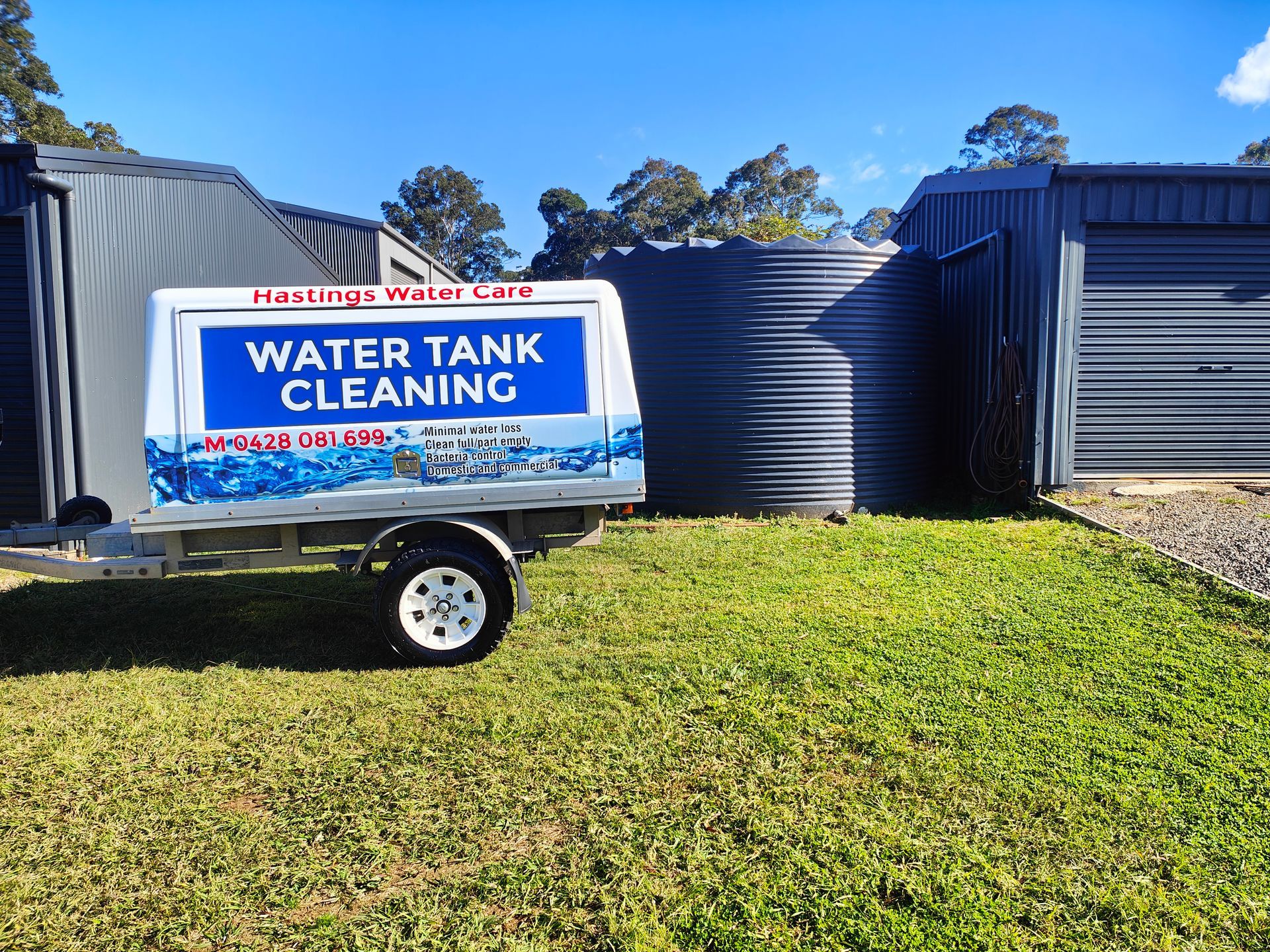 Branded work ute in front of a water tank - Hastings Water Care in Port Macquarie NSW