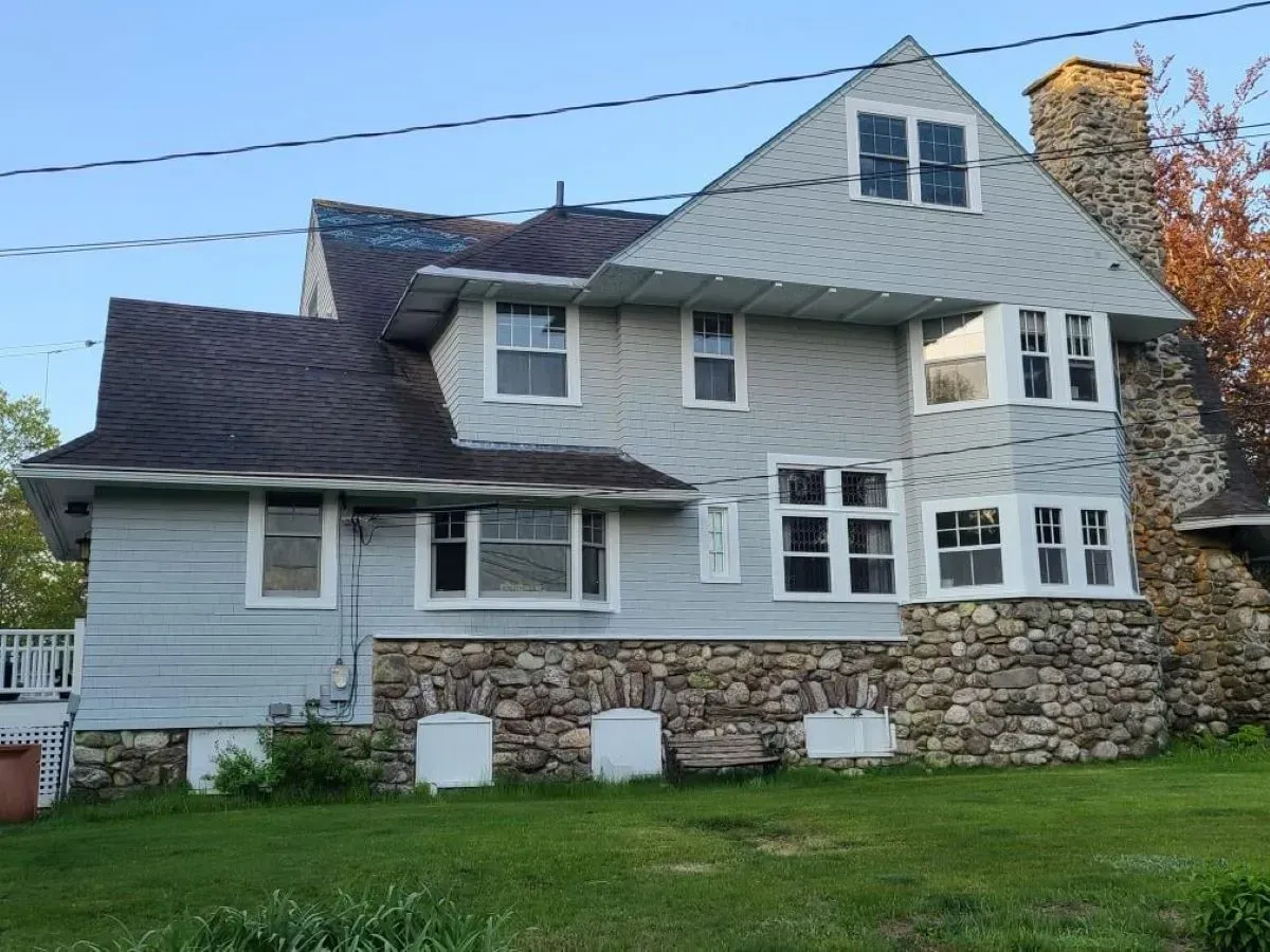 A large house with a lot of windows and a chimney