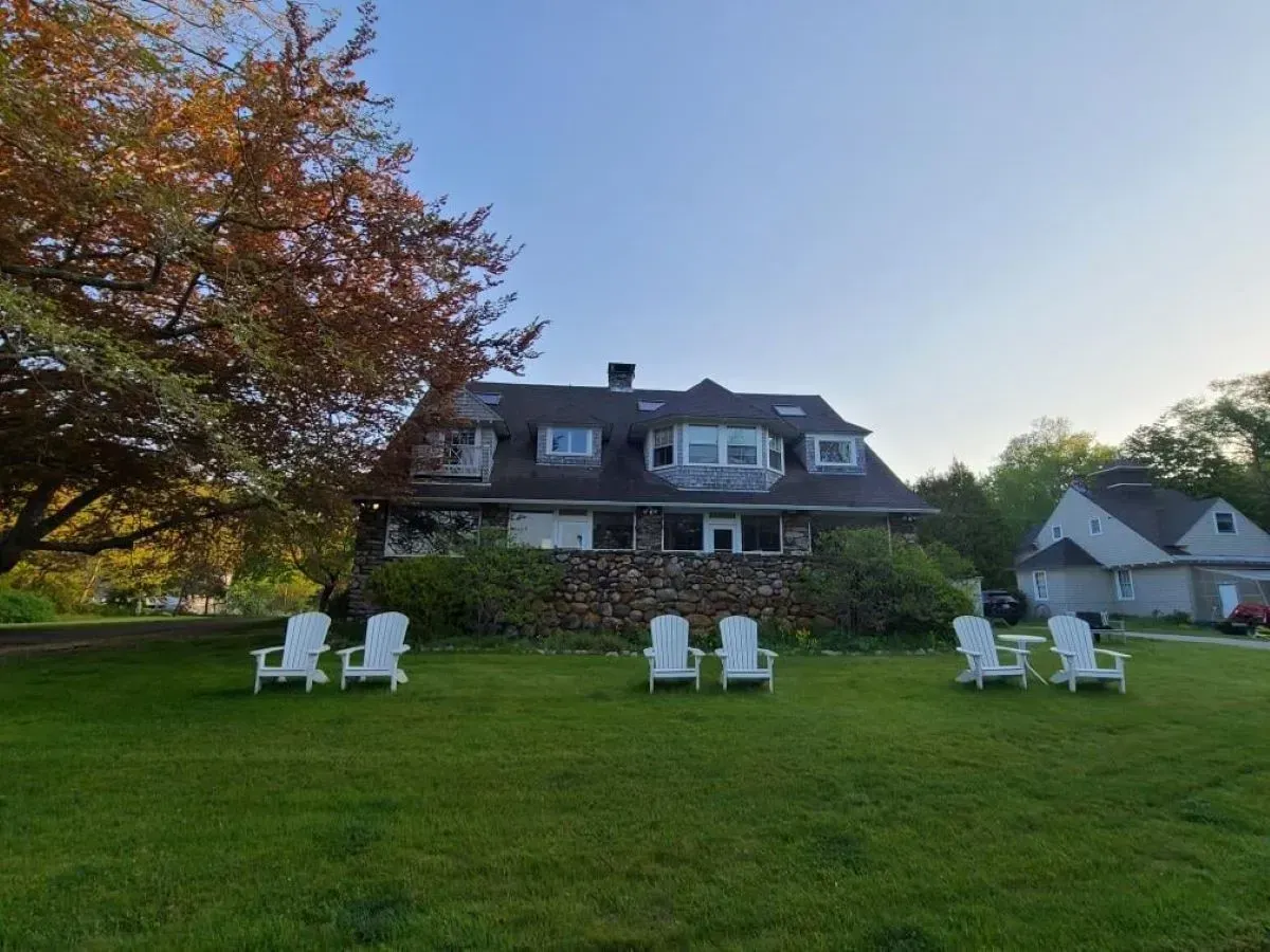 A house with a lot of chairs in front of it