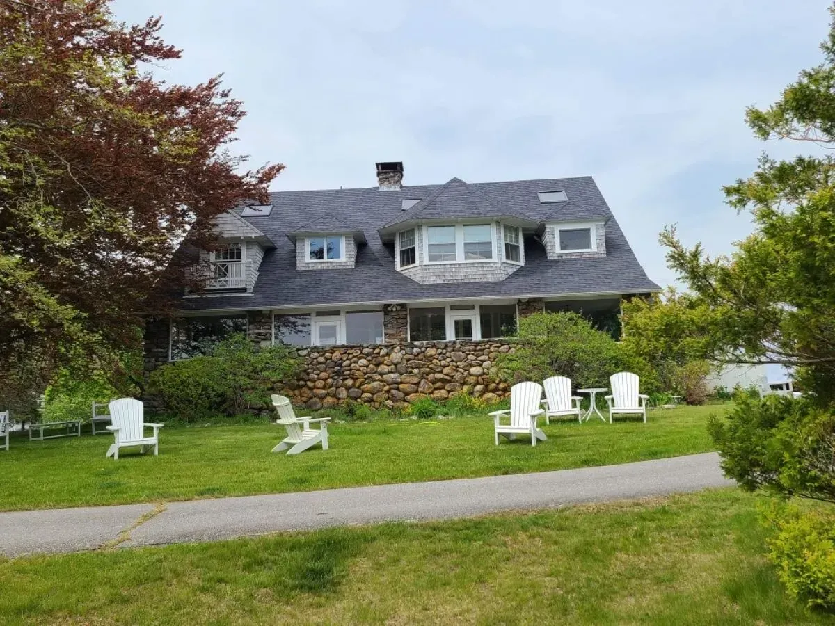 A large house with a lot of chairs in front of it