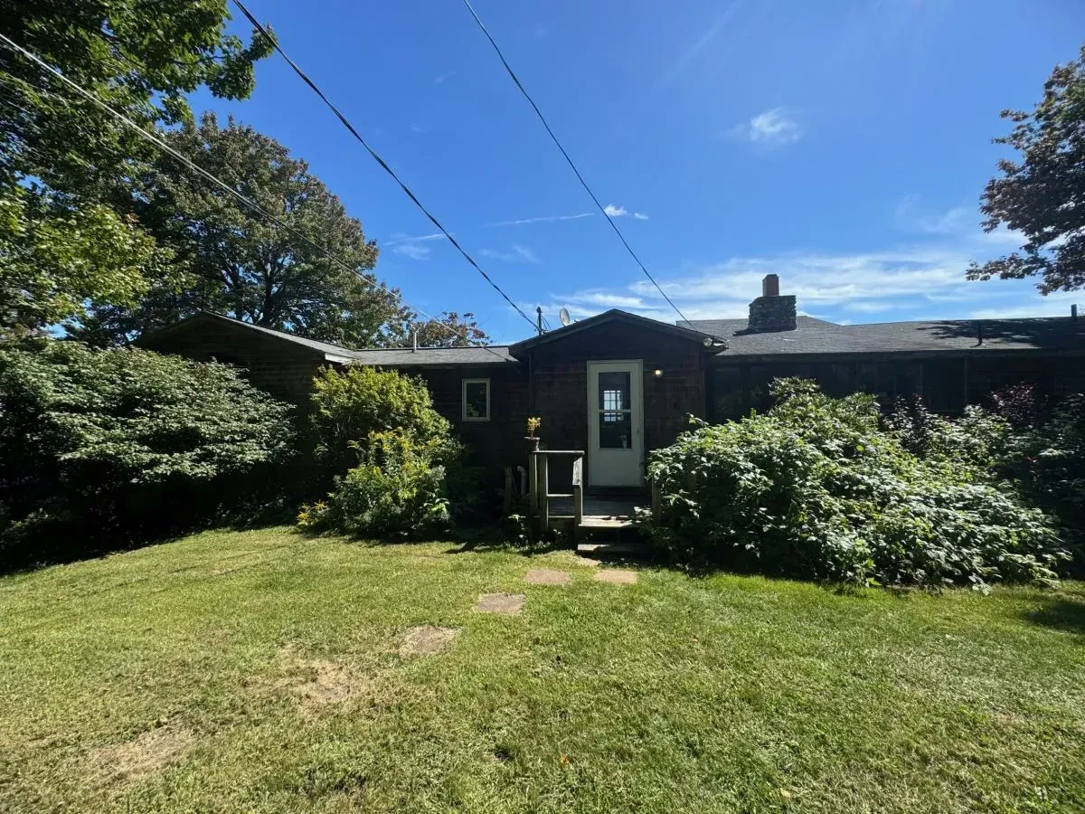 A house with a lot of grass in front of it