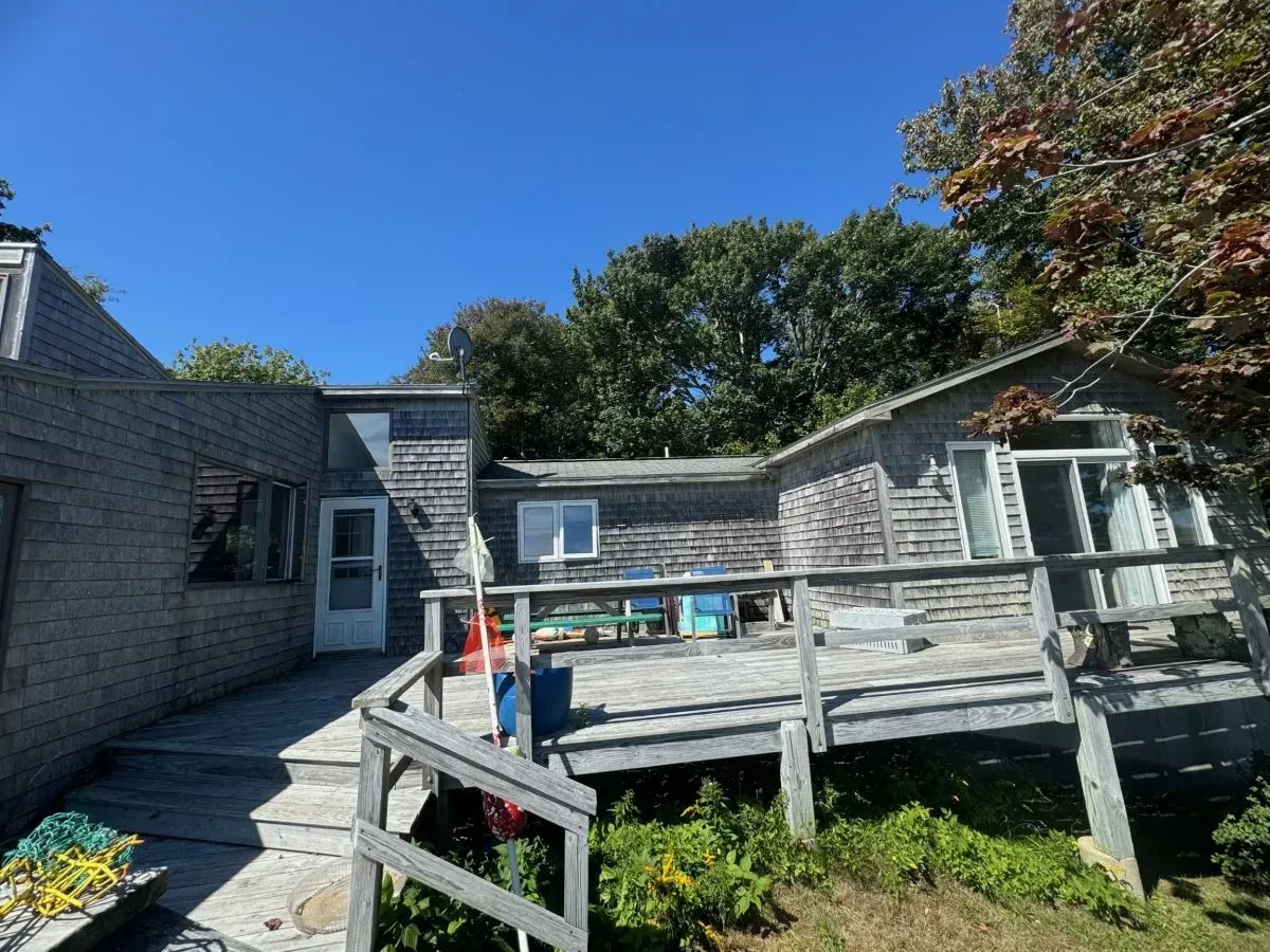 A house with a deck and stairs leading to it
