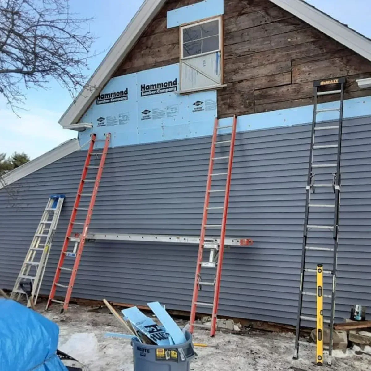 A house that is being remodeled with a ladder on the side