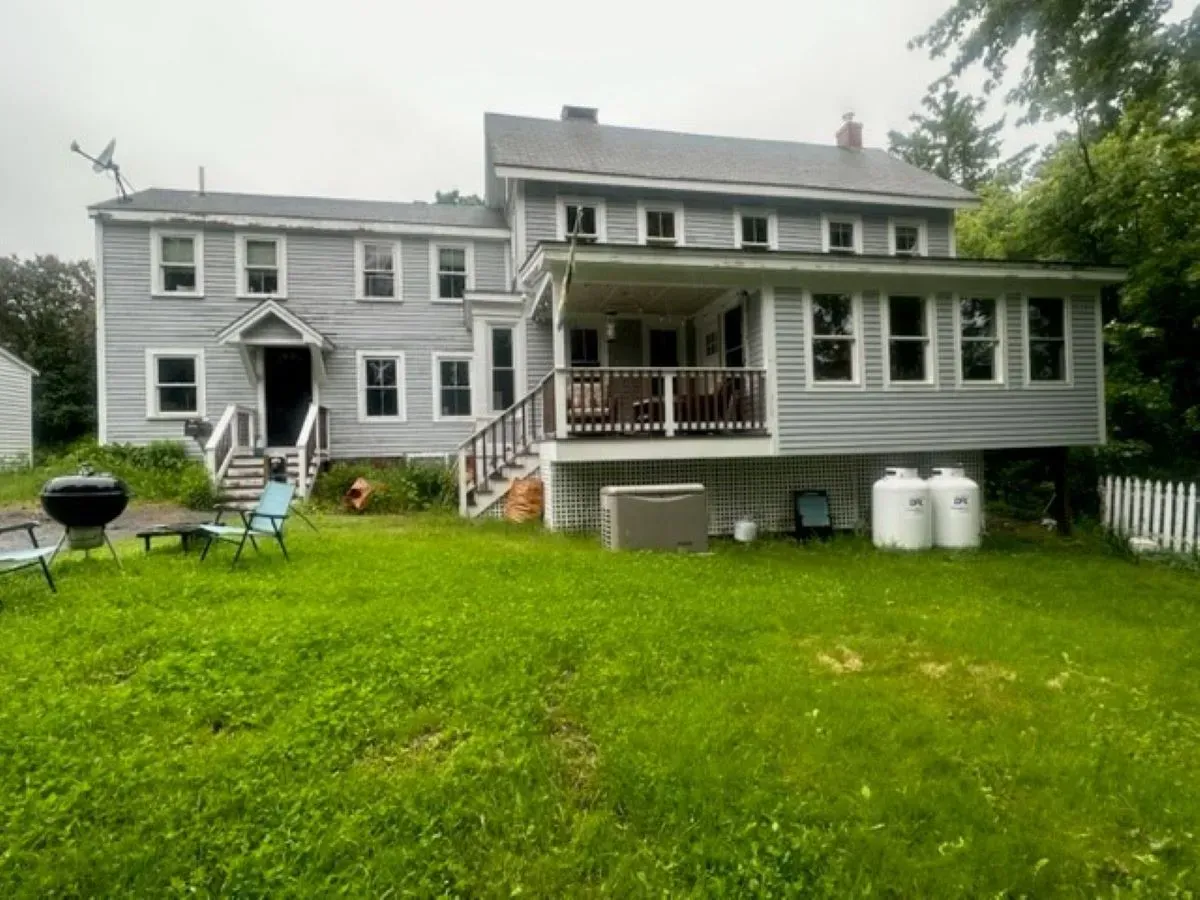 A large house with a large lawn in front of it