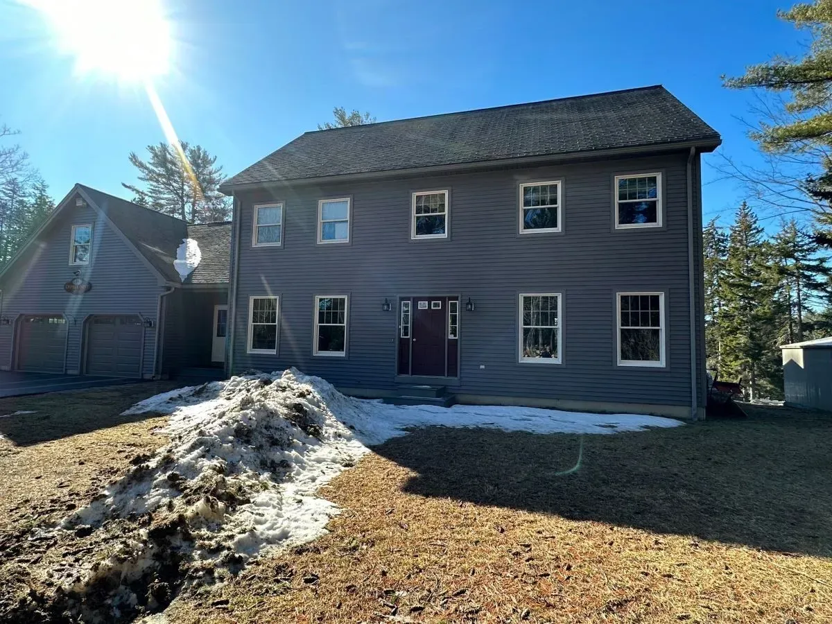 A large house with a lot of windows and a red door