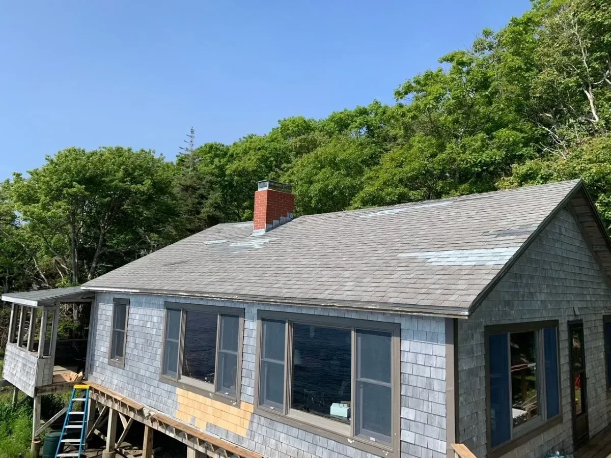 A house is being built on stilts with a ladder in front of it.