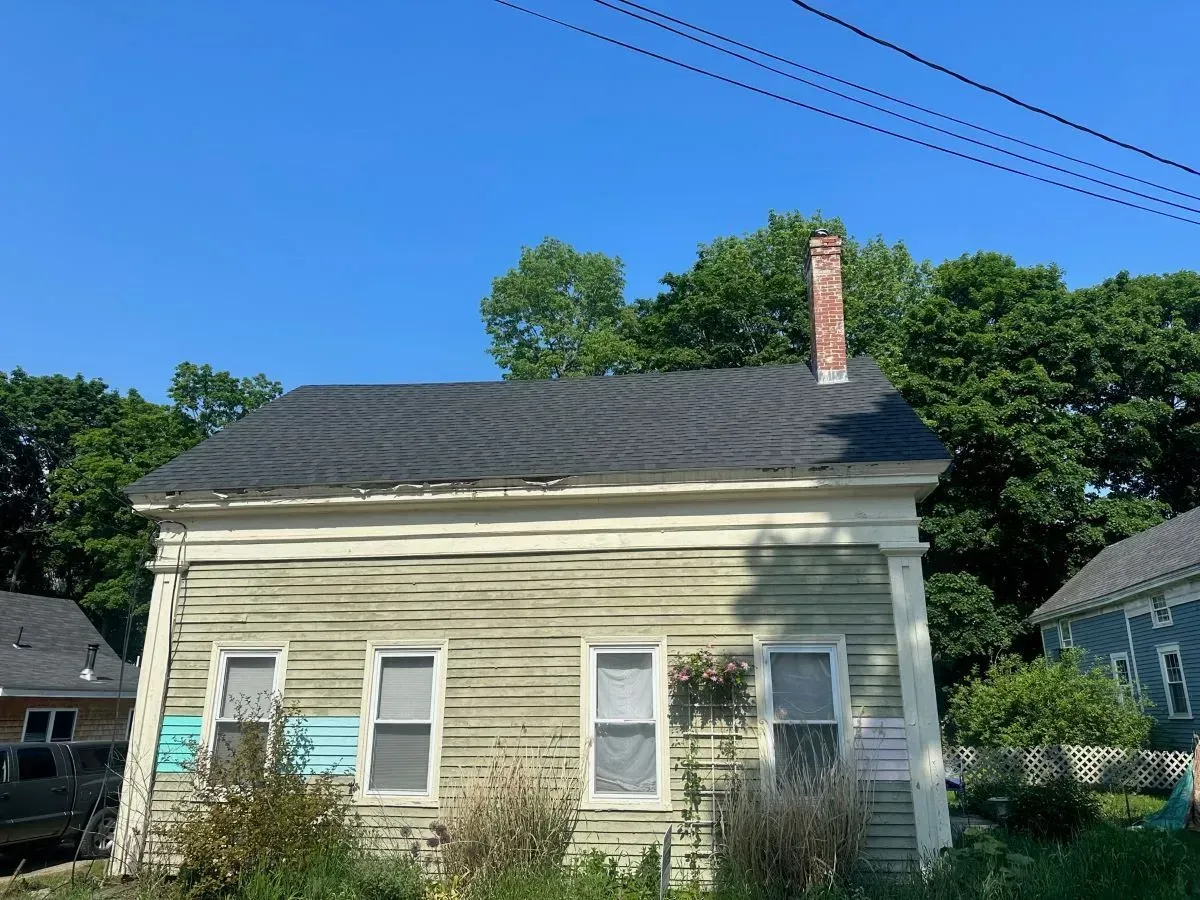 A small house with a chimney on the roof