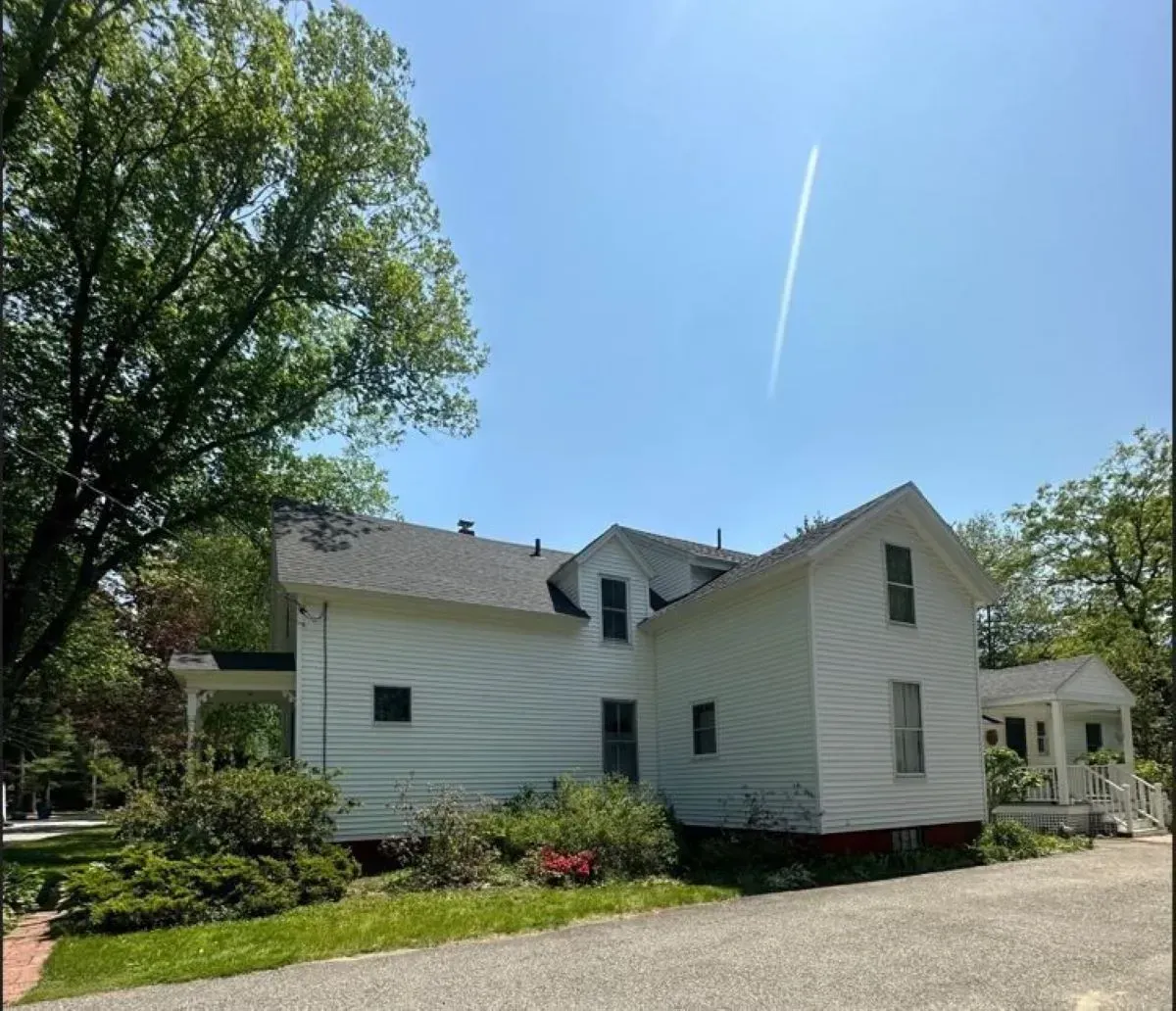 A white house with a blue sky in the background