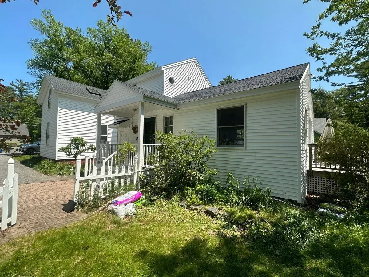A white house with a white fence in front of it