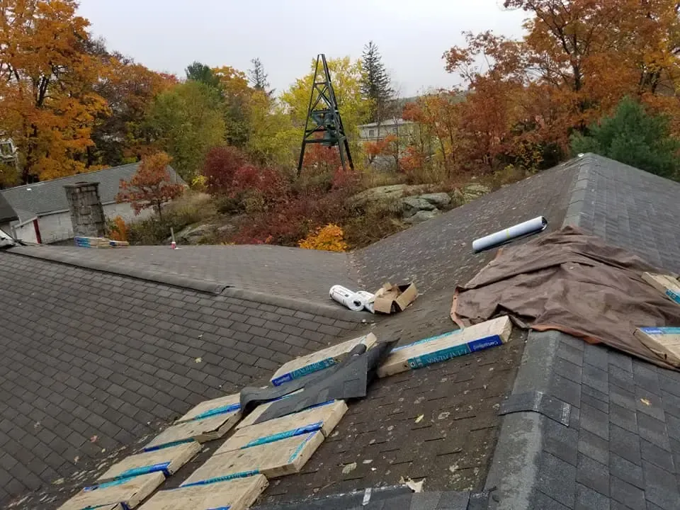 A roof with a lot of boxes on it is being repaired.