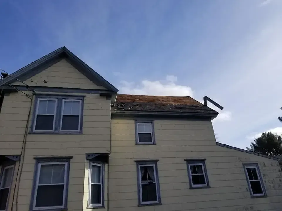 A house with a roof that is missing shingles