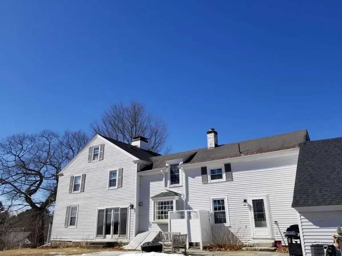 A large white house with a blue sky in the background