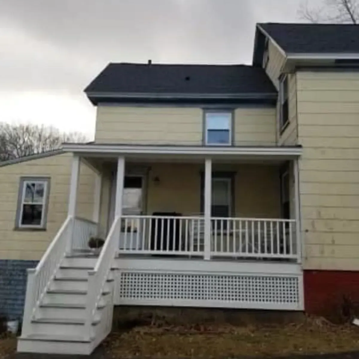 A house with a porch and stairs leading up to it