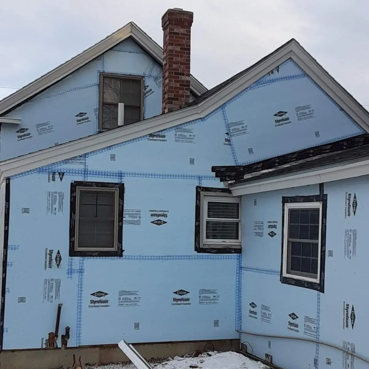 A house with a lot of blue insulation on it