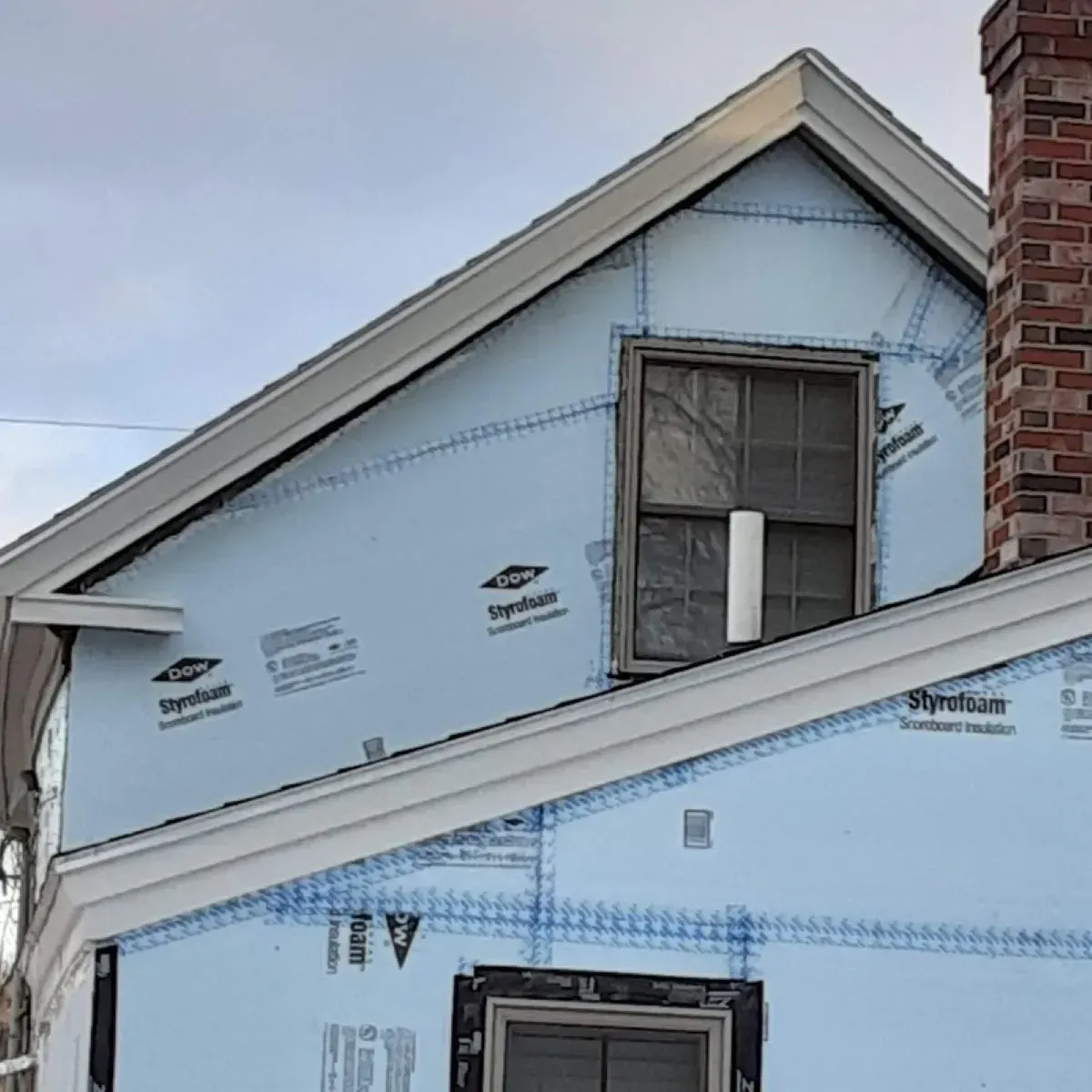 A house with a window and a chimney is being remodeled.