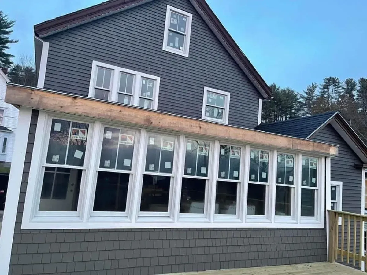 A large house with a lot of windows is under construction.