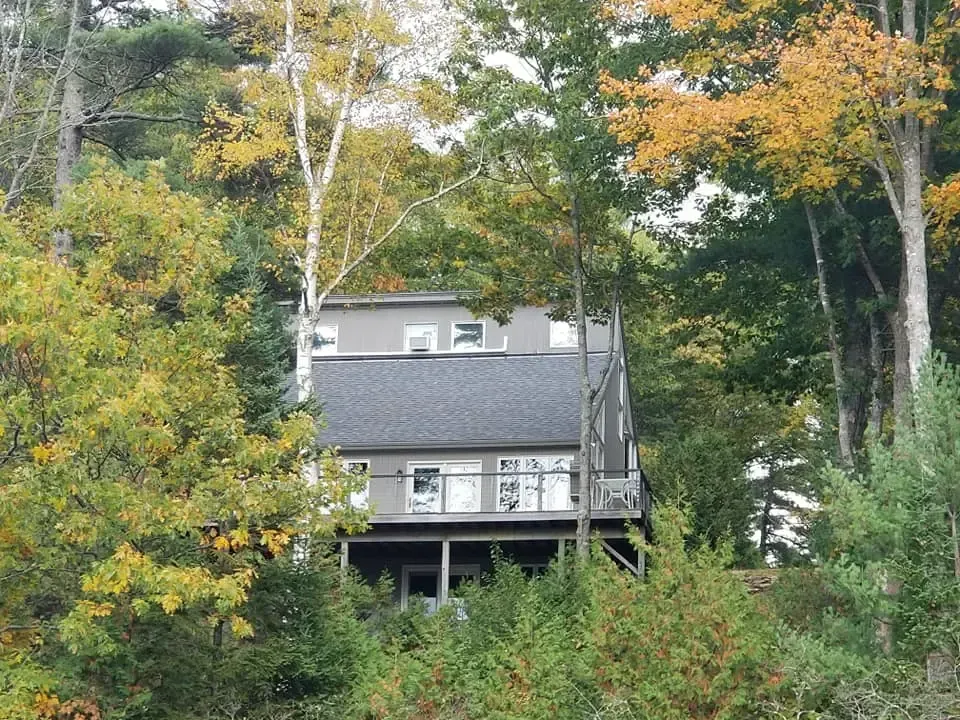 A house sitting on top of a hill surrounded by trees