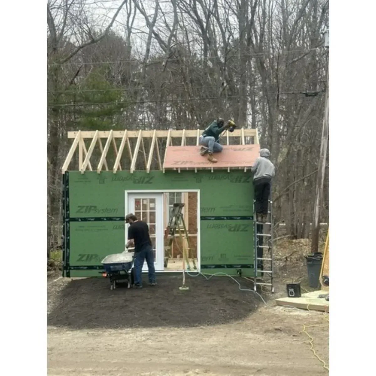 A group of people are working on the roof of a building.