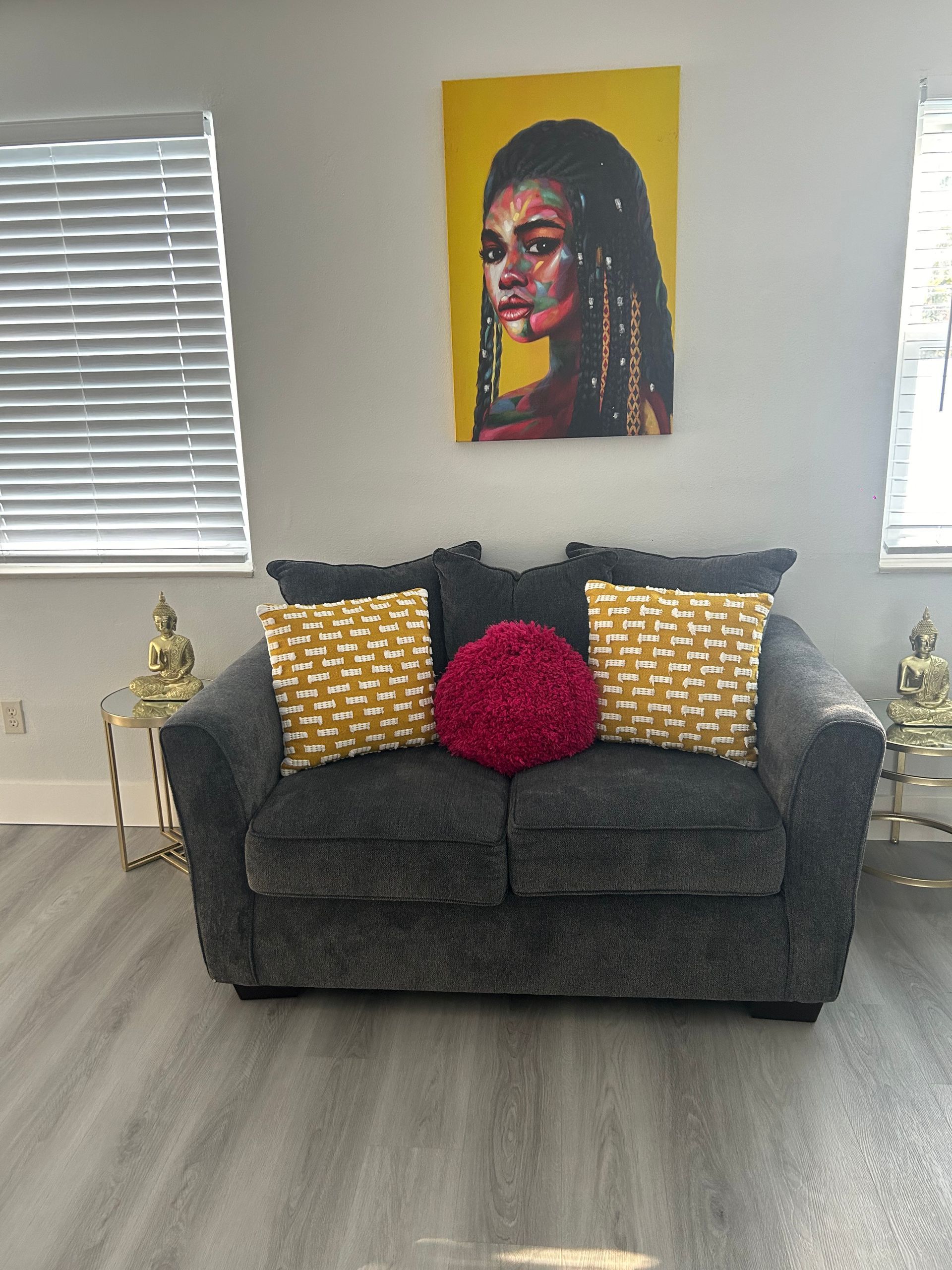 A living room with a couch and a painting on the wall