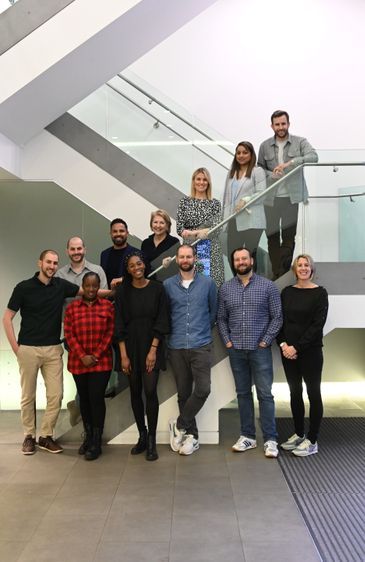 A group of people are posing for a picture on a set of stairs.