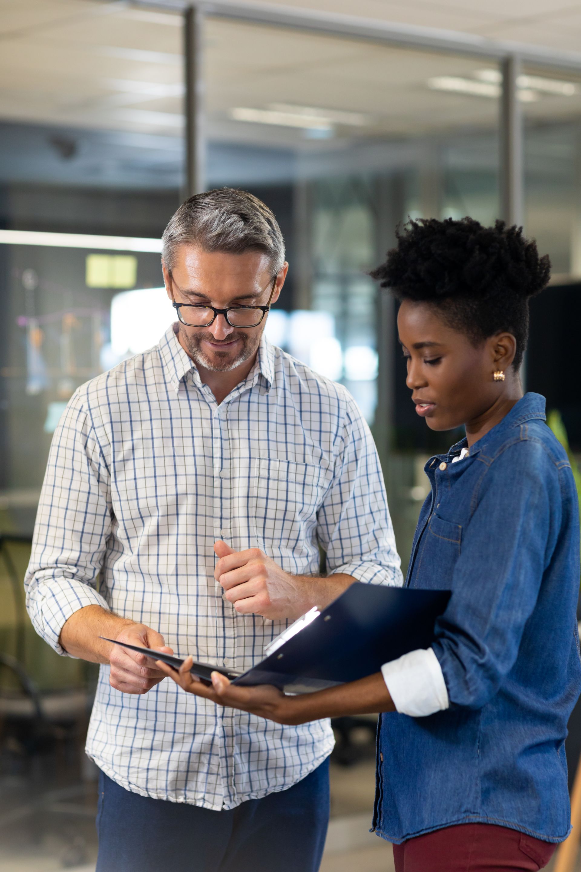 A man and a woman are looking at a job description brief together.