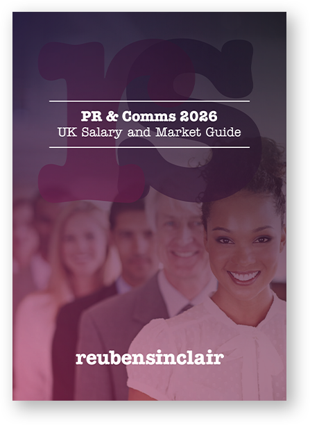 A group of people are sitting on the floor in front of a sign that says ' pr & comms 2024 uk salary guide '