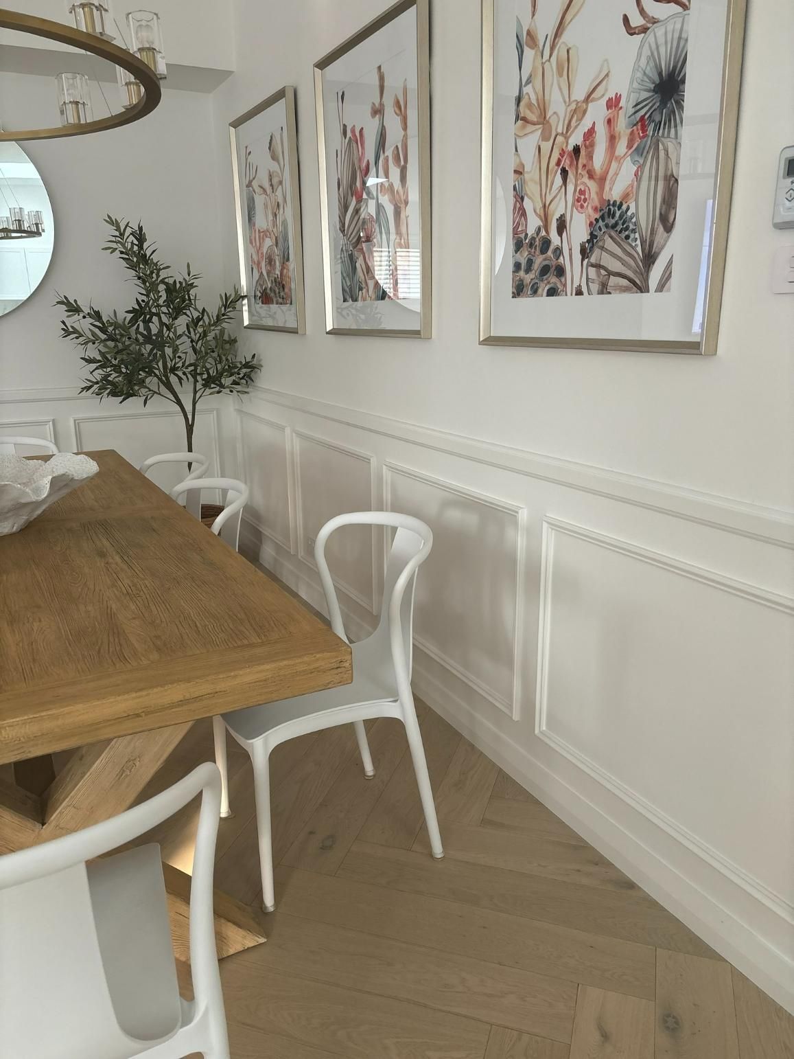 A Dining Room With A Wooden Table And White Chairs — Nique Building In Erina Heights, NSW