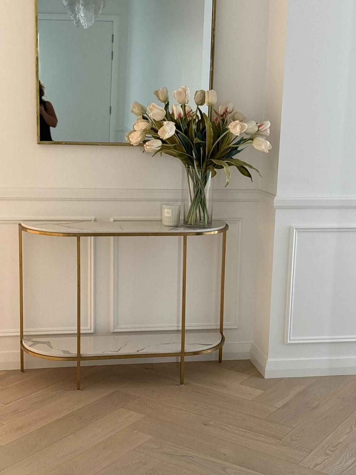 A Vase Of Flowers Is Sitting On A Table Next To A Mirror — Nique Building In Erina Heights, NSW