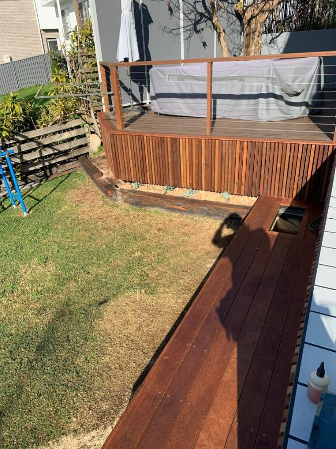 A Wooden Deck In A Backyard Next To A Pool — Nique Building In Morisset, NSW