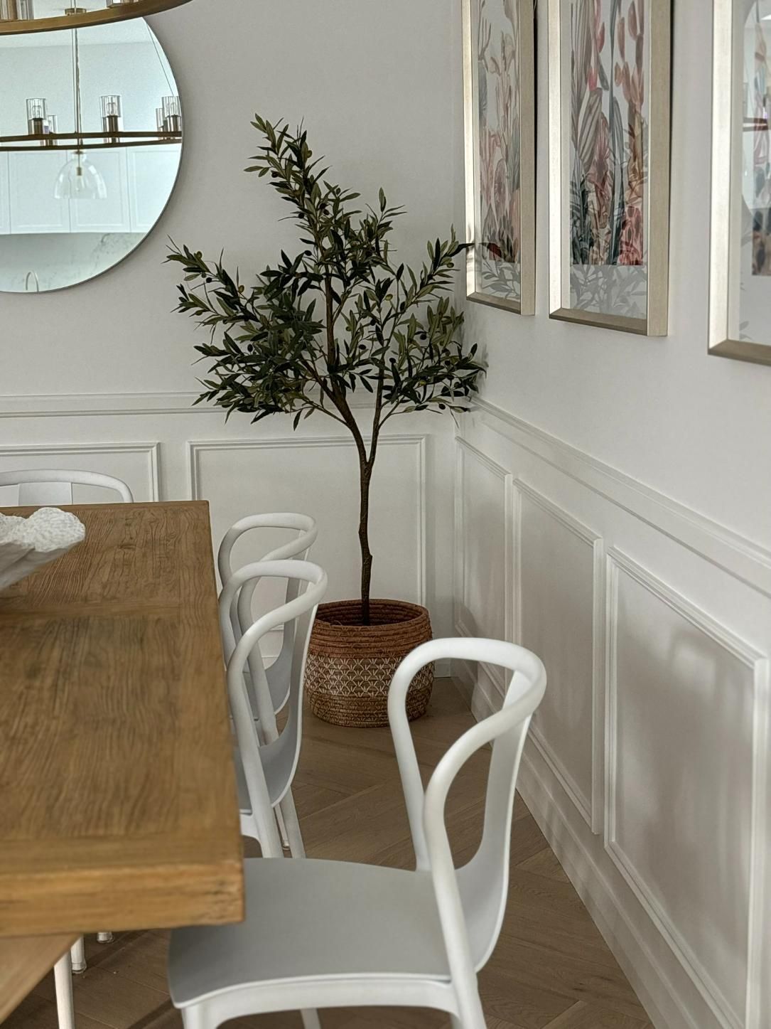 A Dining Room With A Table And Chairs And A Potted Plant — Nique Building In Bateau Bay, NSW